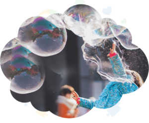 Child playing with large soap bubbles outdoors during a fun activity